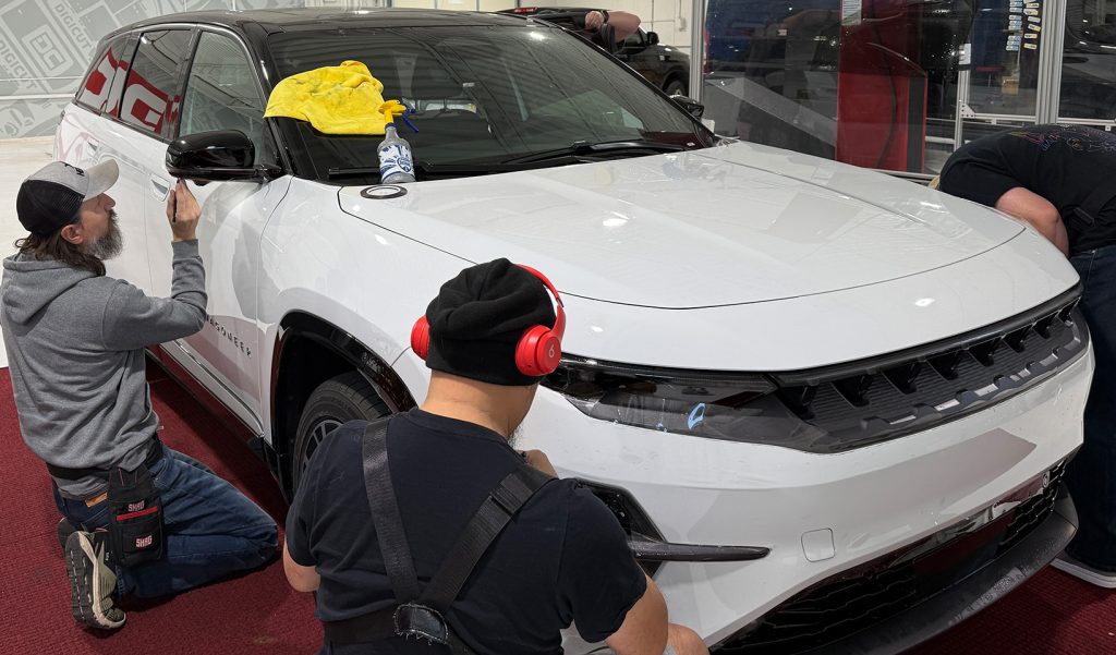 DigiCut team hand building patterns on a vehicle.